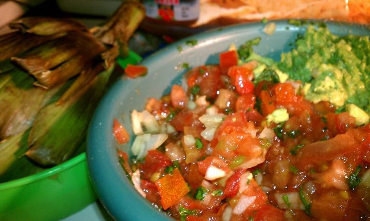 Homemade salsa guacamole and steamed artichoke